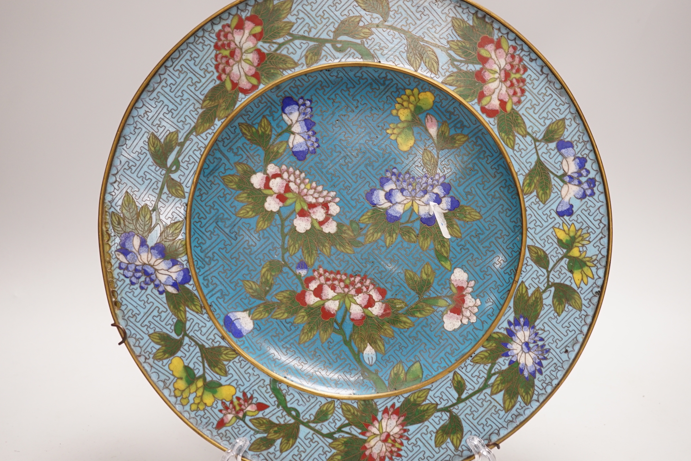 A Chinese Jiaqing period cloisonné enamel dish on a turquoise ground with floral decoration, 27.5cm